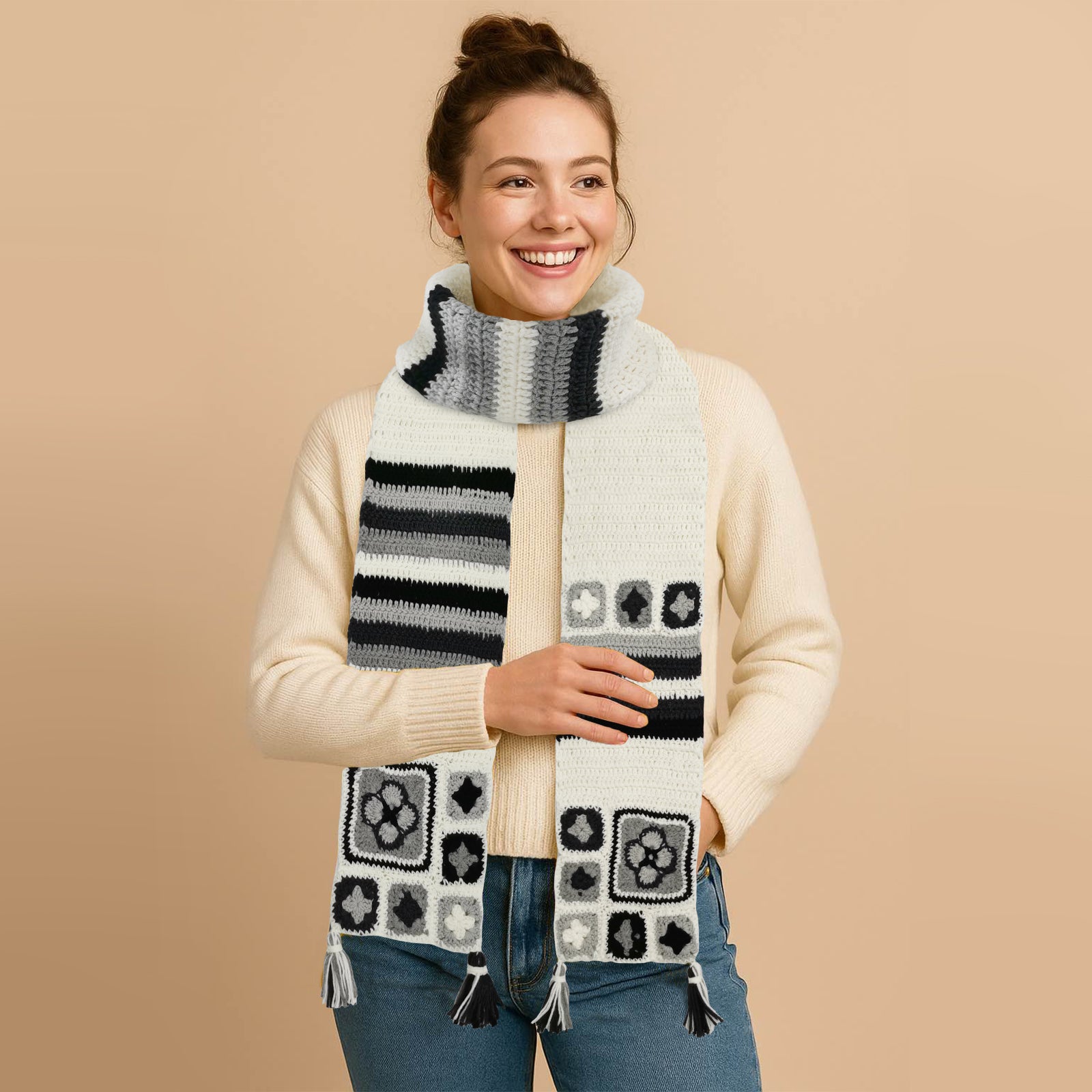 Woman wearing an ivory granny square crochet scarf with colorful stripes and patterns