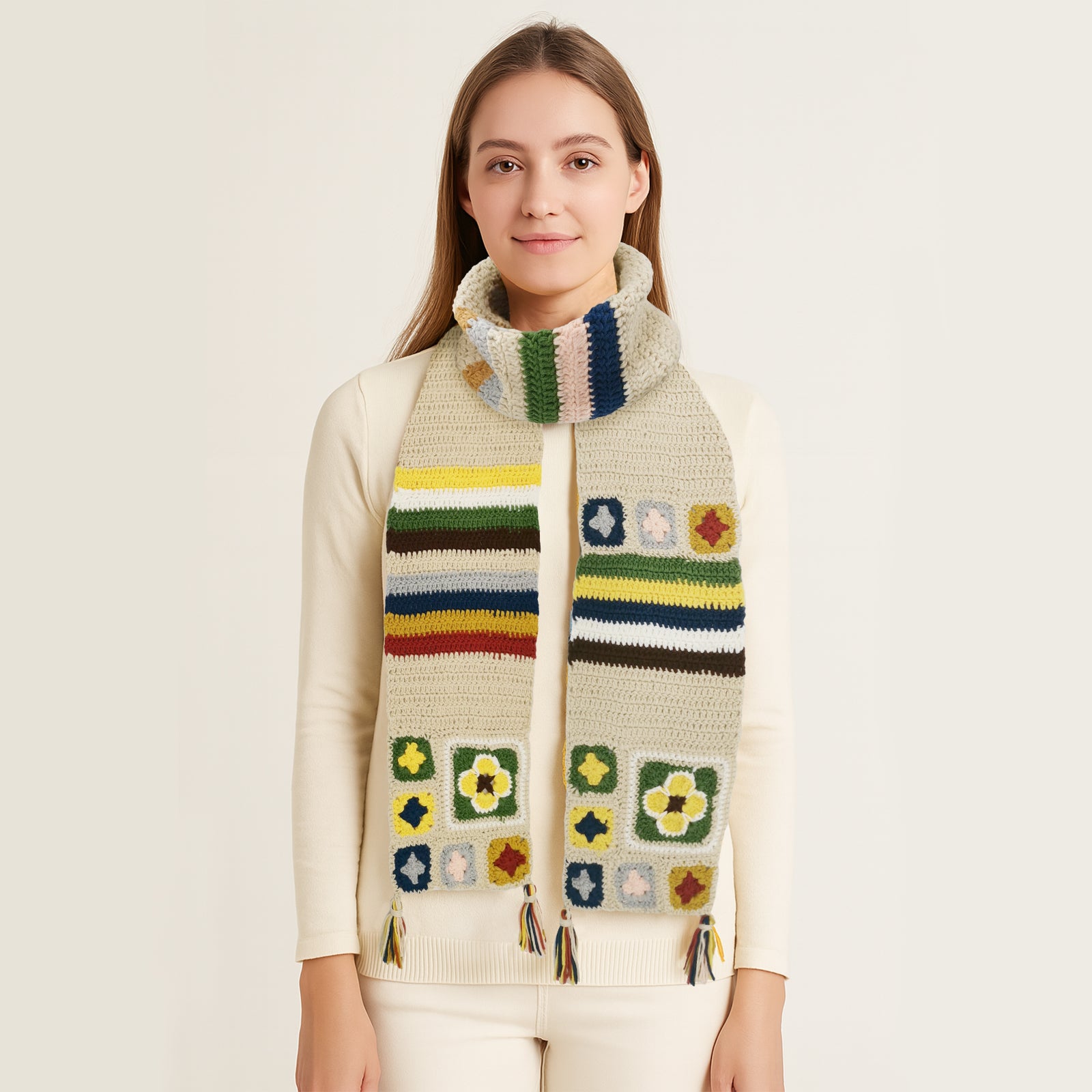 Woman wearing a creamy granny square crochet scarf with colorful patterns