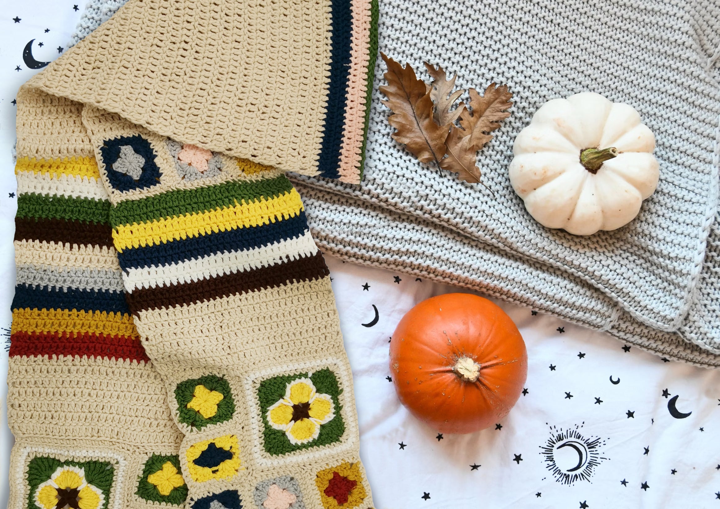 Creamy granny square crochet scarf displayed with knitted blankets and pumpkins in a cozy setting