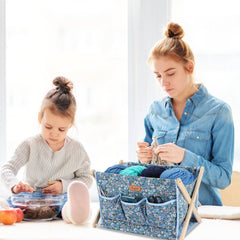 Mother and daughter crafting scene with woolique blue floral-patterned yarn organizer holding knitting supplies