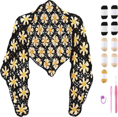 Complete crochet kit for black and beige daisy shawl, showing finished lace wrap and materials