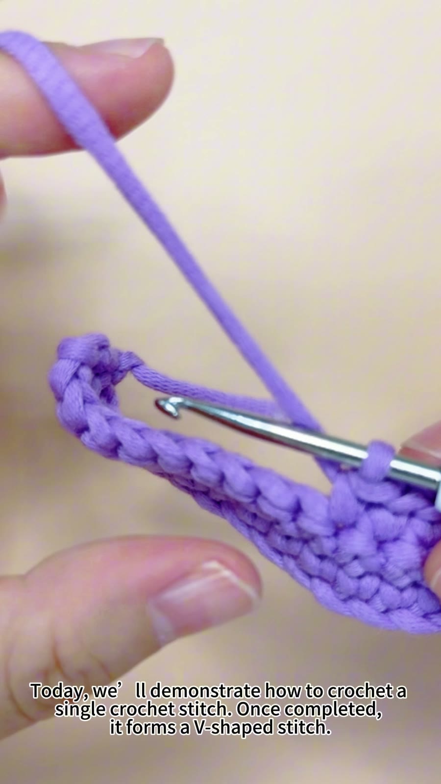 Close-up demonstration of a single crochet stitch